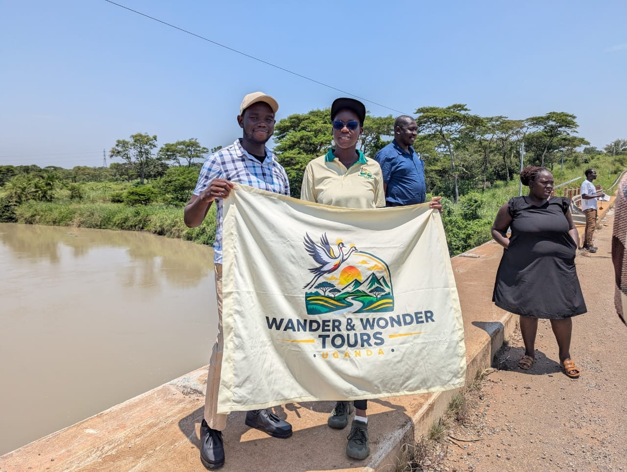 Guide leading a small group through central Gulu streets, Gulu Heritage Tours, Gulu