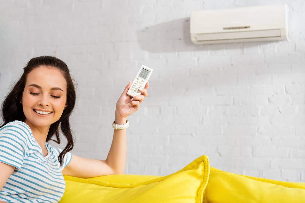 Woman Holding AC Remote