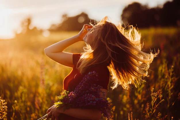 woman-red-dress-whirls-rays-evening-sun-8353-251.webp