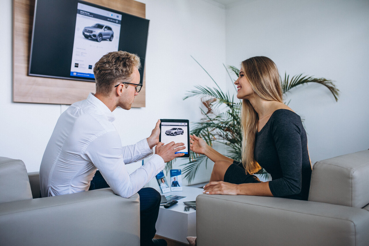 Common Myths About Buying Used Cars Man-woman-car-showroom-using-tablet-Easy-Resize-com