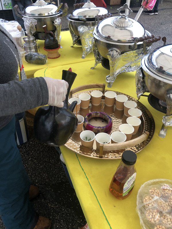 Traditional Ethiopian coffee ceremony with jebena clay pot and roasted beans