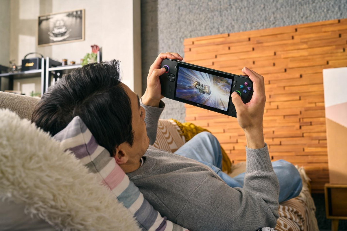 A person lying on a couch holding a video game controllerDescription automatically generated A person lying on a couch holding a video game controllerDescription automatically generated