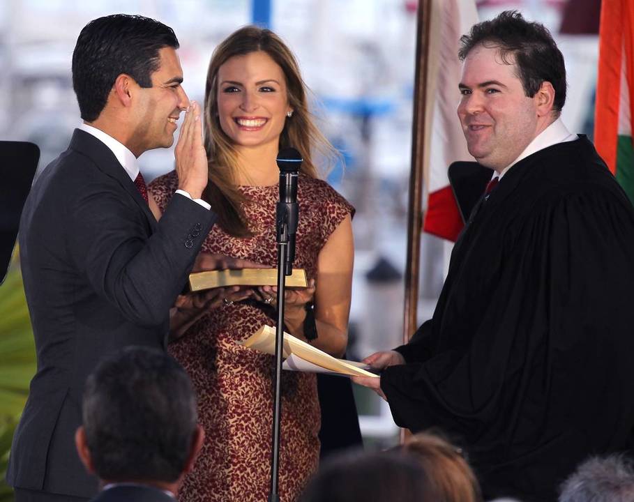 Francis Suarez is sworn in (while his wife, Gloria, holds the Bible) by Judge Robert Luck, right, during a public ceremony at City Hall on November 15, 2017