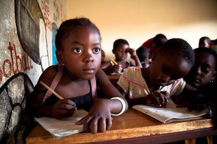 Children writing during an education event