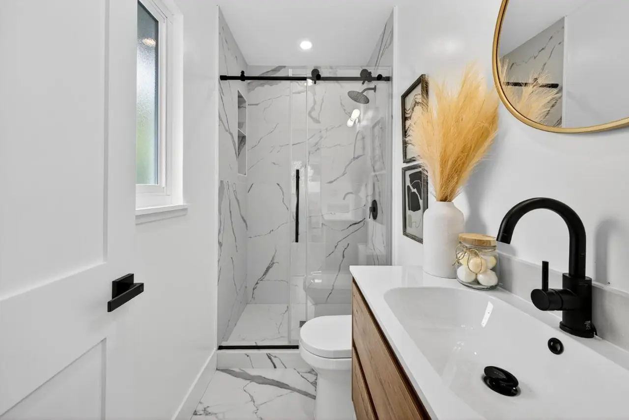 Compact bathroom with matte fixtures and smart storage