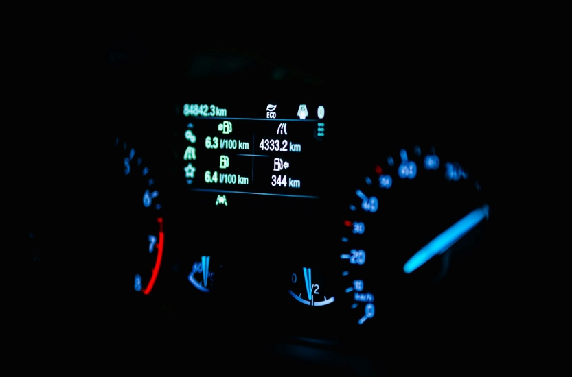 car odometer showing 84,823 km and dashboard information display
