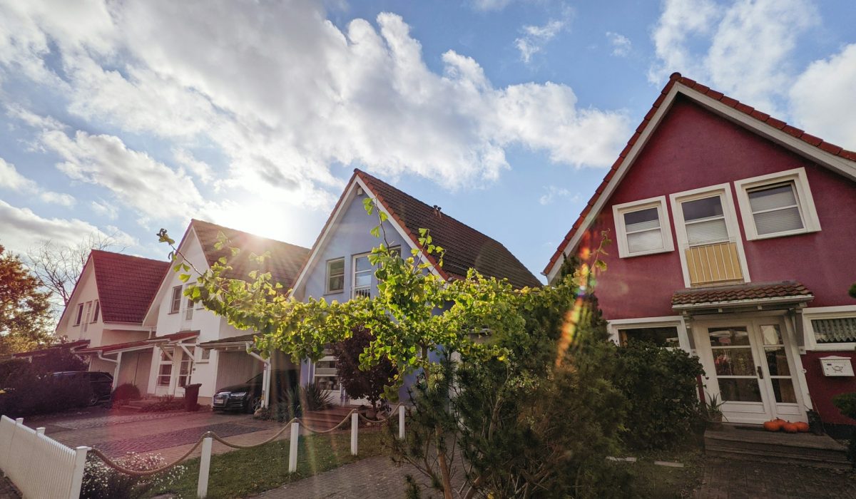 Rooftops of houses against a sunny sky