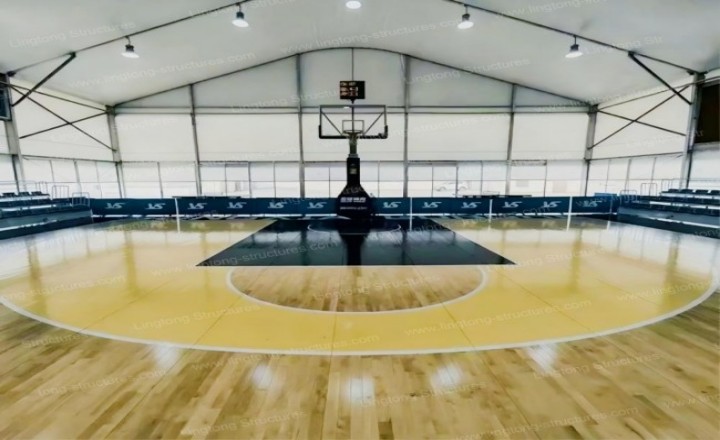 Large-scale basketball competition venue with spectator seating and event lighting
