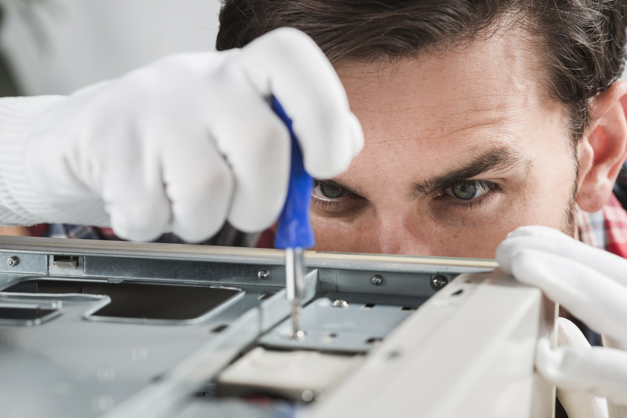 close up male technician repairing cpu with screwdriver