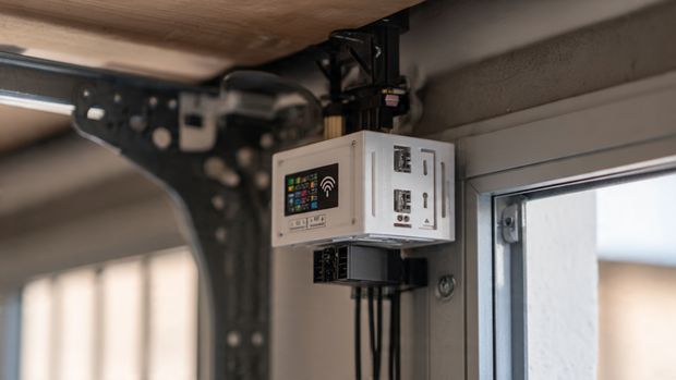 Smart garage door controller showing WiFi module and door position sensors