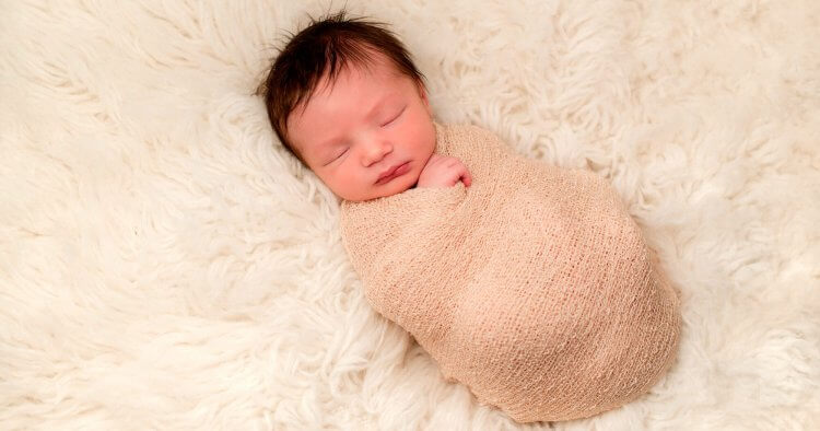 How should you wrap a baby while they sleep