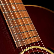 Why does my guitar buzz - acoustic guitar strings and fretboard