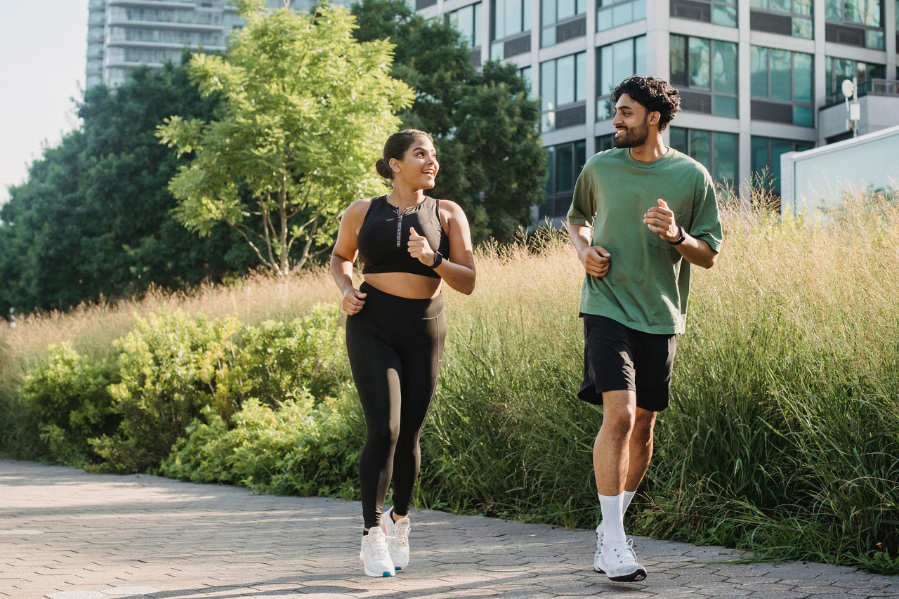 Two beginner runners on a couch to 5km run jogging together outdoors