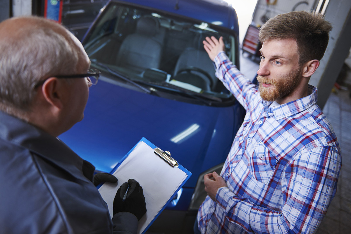Common Myths About Buying Used Cars Customer-talking-with-mechanic-workshop-Easy-Resize-com