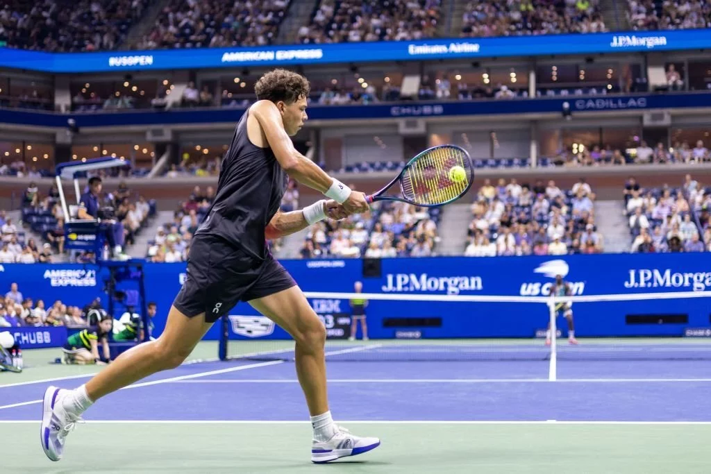 Ben Shelton serving during the match with Tiafoe