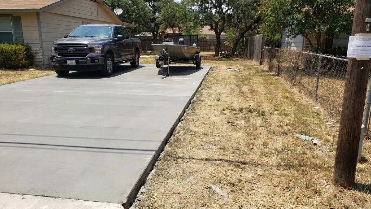 Concrete side yard parking pad in San Antonio TX showing extended slab alongside a home for RV or trailer parking on an improved surface