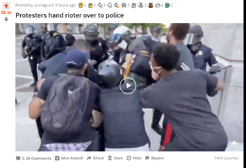 protesters-hand-rioter-over-to-police.png