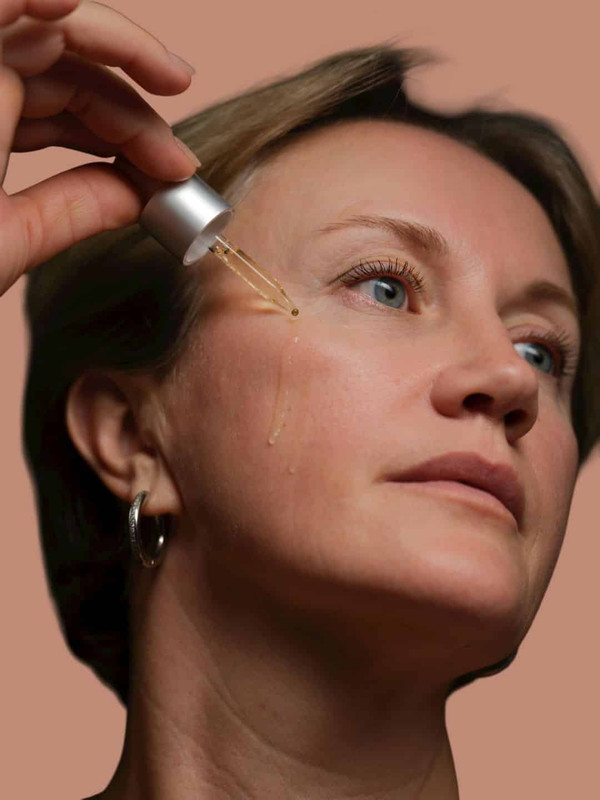 A woman using Vitamin C for skin elasticity and skin tightening