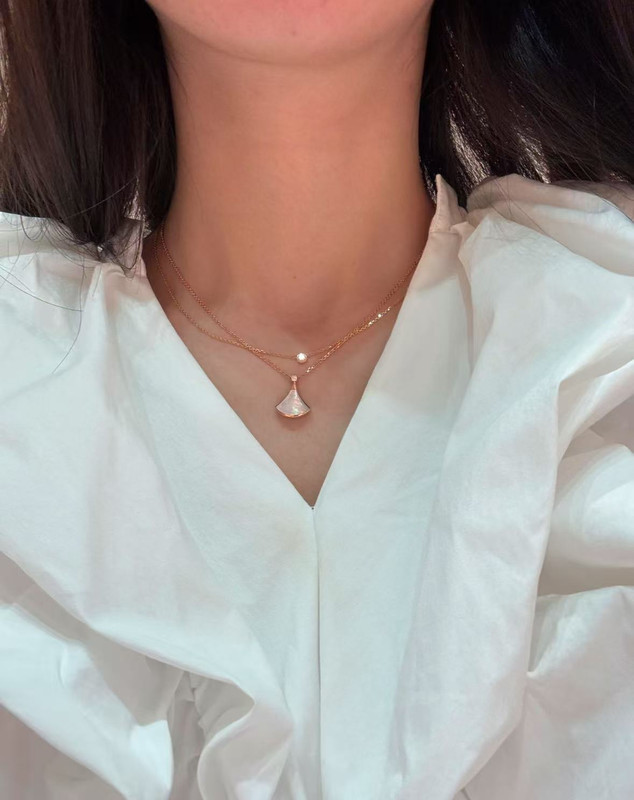 Fan shaped necklace worn by model
