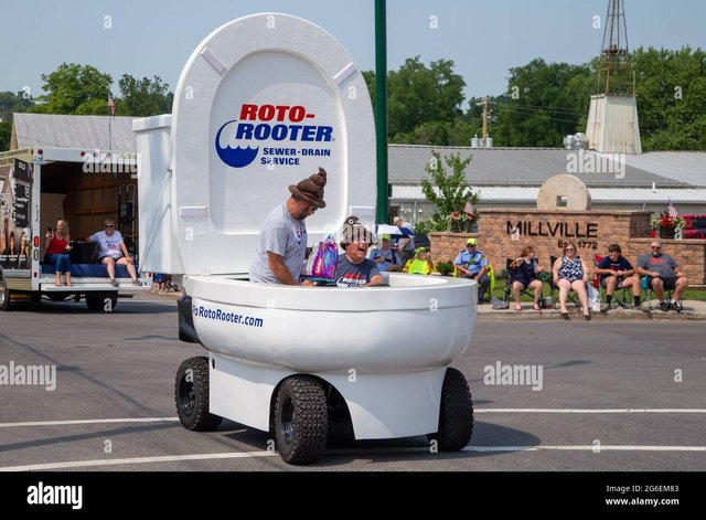 millville-united-states-05th-july-2021-two-men-drive-a-toilet-shaped-vehicle-sponsored-by-roto-roote.jpg