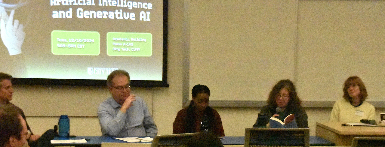 five people sitting on a panel during a reading