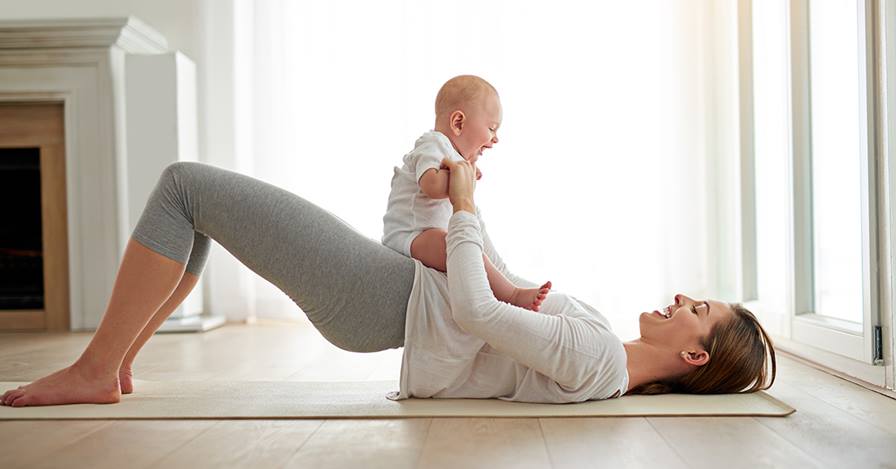 Image of a mother holding her baby after performing postpartum treatment at Pelvic Health PT in Madison, NJ.