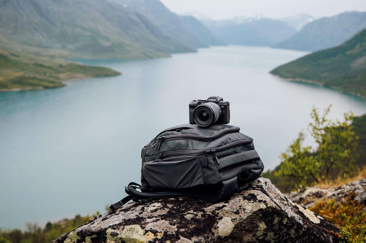 Canon EOS R8 Mark II on a camera bag overlooking a mountain lake