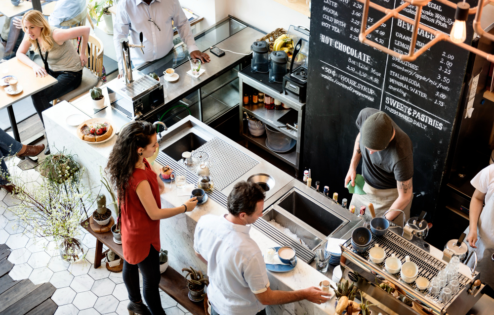 A diverse group of students working in a modern cafe shop