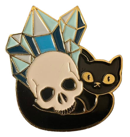 an enamel pin of a cartoon-styled black cat with big, yellow eyes and blue crystals sticking out behind it-- a skull sitting on its stomach, with its tail wrapped around it