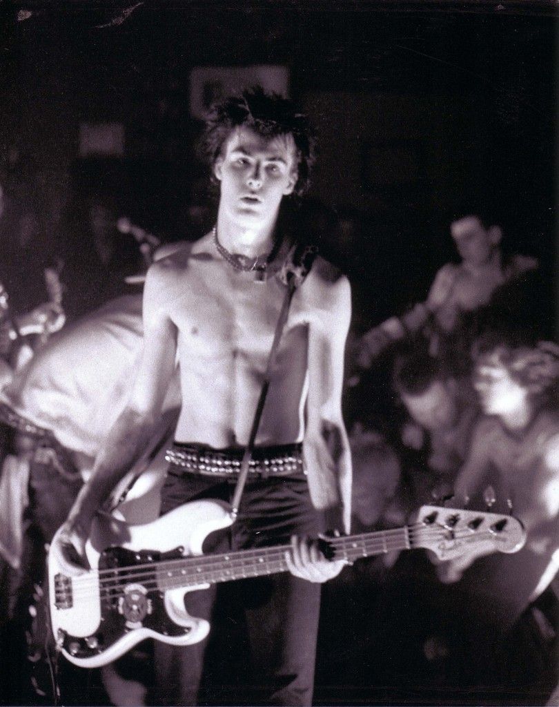 Sid Vicious playing bass on stage