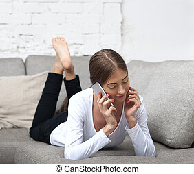 beautiful-girl-lying-on-the-couch-and-talking-on-the-phone-without-shoes-stock-images-csp43341553.jpg