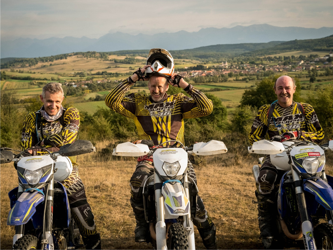 Riding group on Shercos bikes, Carpathian mountains in background