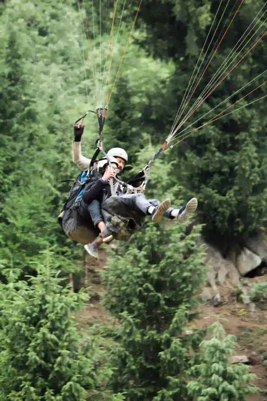 Couple paragliding in Shimla Manali by ThrillMyTravel