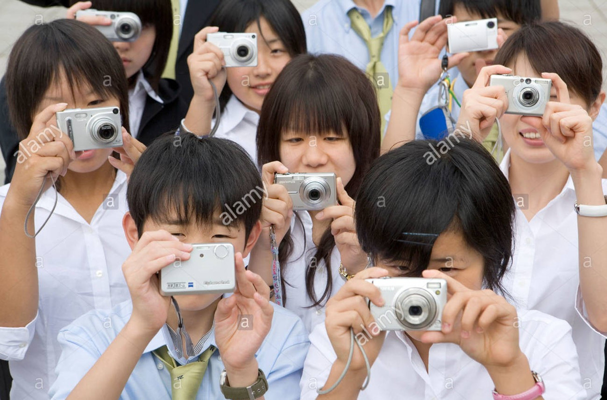 japanese-tourists-taking-photographs-in-gateshead-uk-ABYBJR.jpg