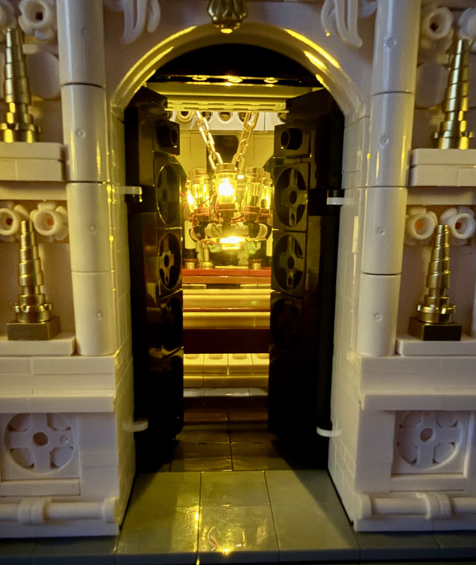 A peek through the front doors at the chandelier.