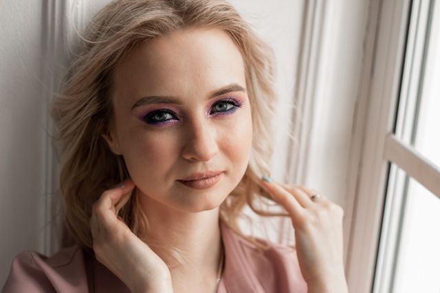 a woman following fall makeup trends wearing Berry, burgundy & cranberry fall makeup colors