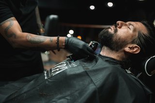 A person getting their beard trimmed