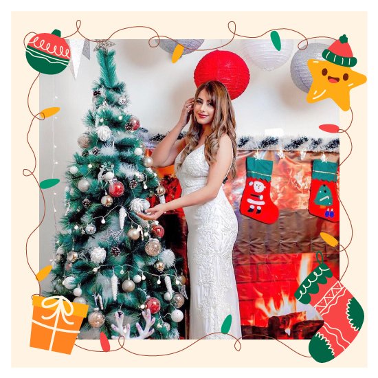 Captivating Christmas decor showcased with a woman posing next to a sparkling Christmas tree display