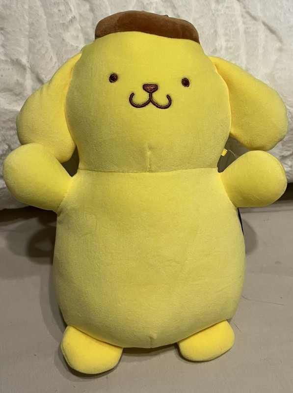 Plush of yellow cartoon dog Pompompurin, with an oddly long body