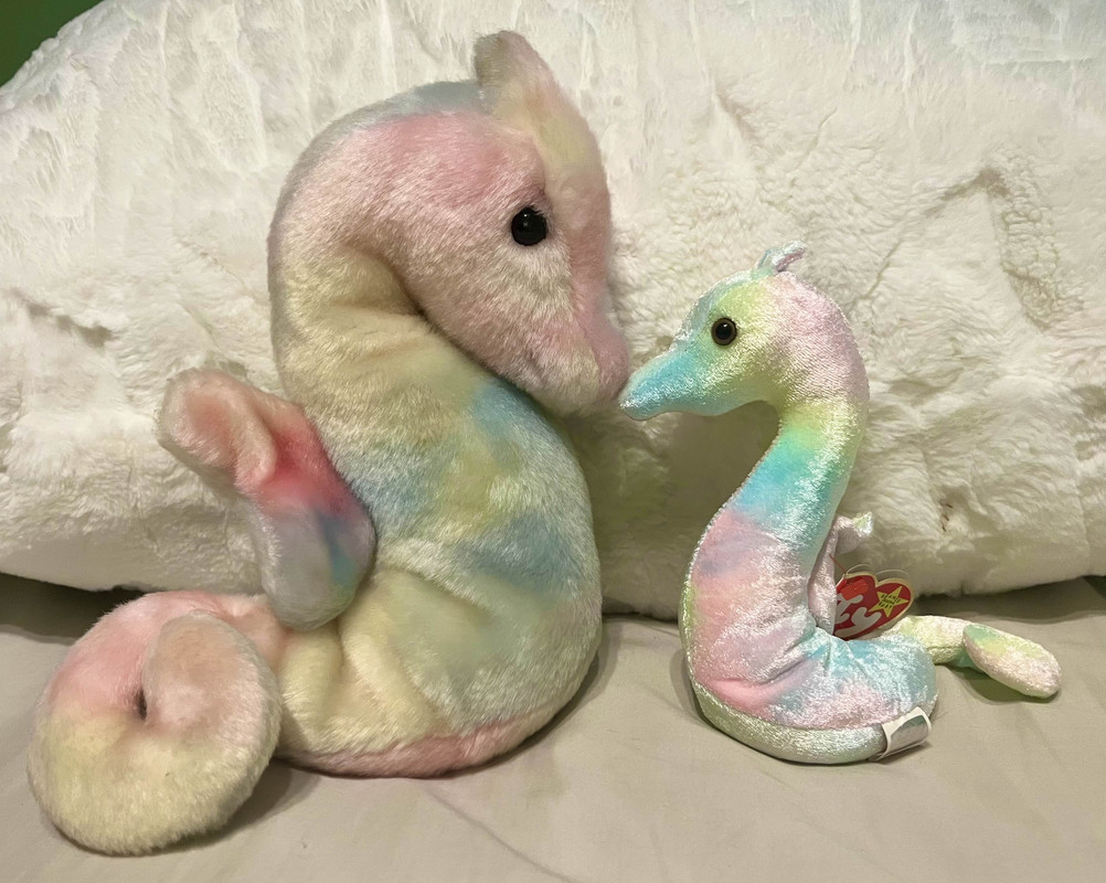 Two rainbow colored seahorse plushes