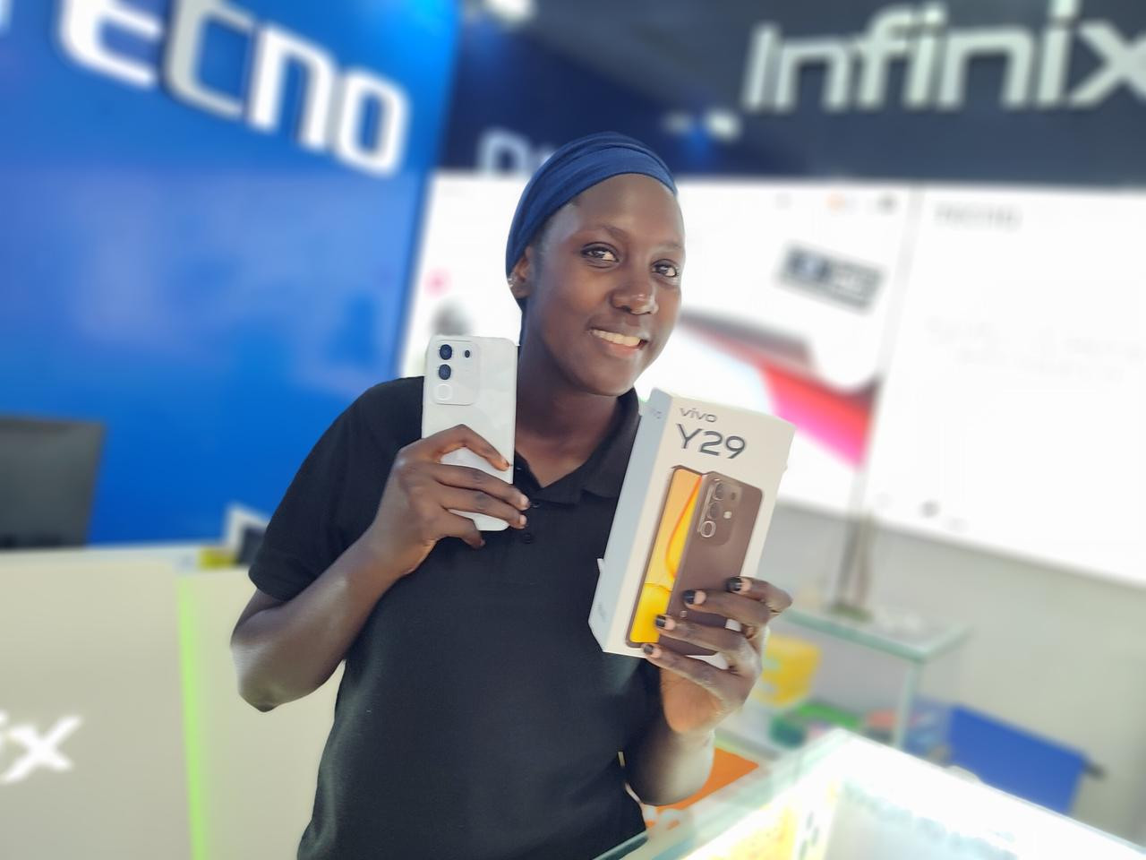 Happy customer holding a new vivo phone box after purchase