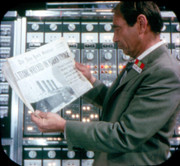 10 Sen. Clark looks at the newspaper Doug is taking back