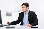21246671-handsome-young-businessman-sitt