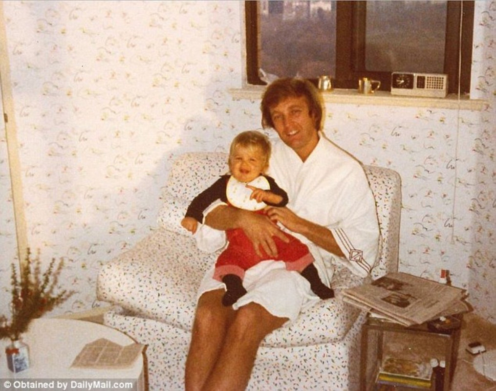 Donald Trump with his son. He is wearing a white bathrobe.