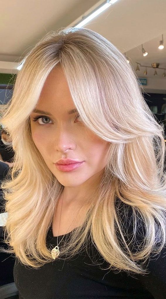 Brunette dyed butter blonde with long bangs