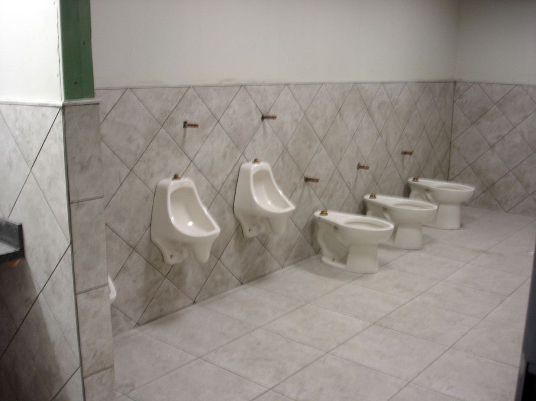 tile install in diagnal on walls reg install on floors set toilets and uriona;s soloan flush system