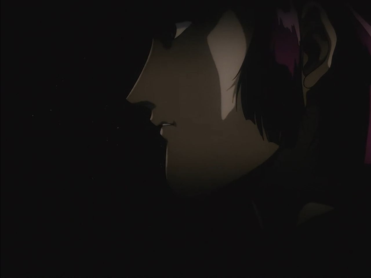 screenshot of a closeup on Haman's face in profile; it's very dark and you can only just make out her features.