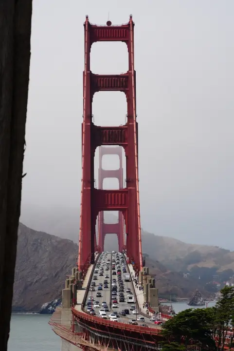 This photo captures the busy traffic on the Golden Gate Bridge on an overcast day.
