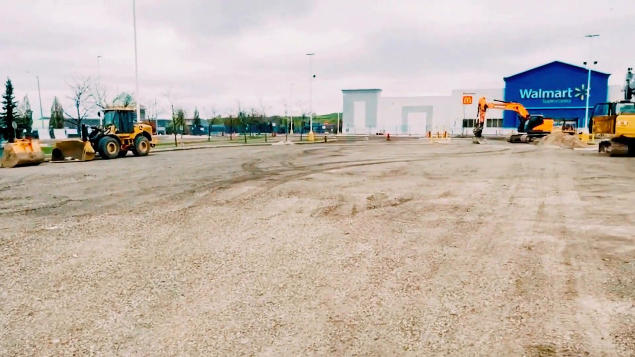Loader, excavator and dozer on the graded parking lot base at the Walmart Heartland Supercentre
