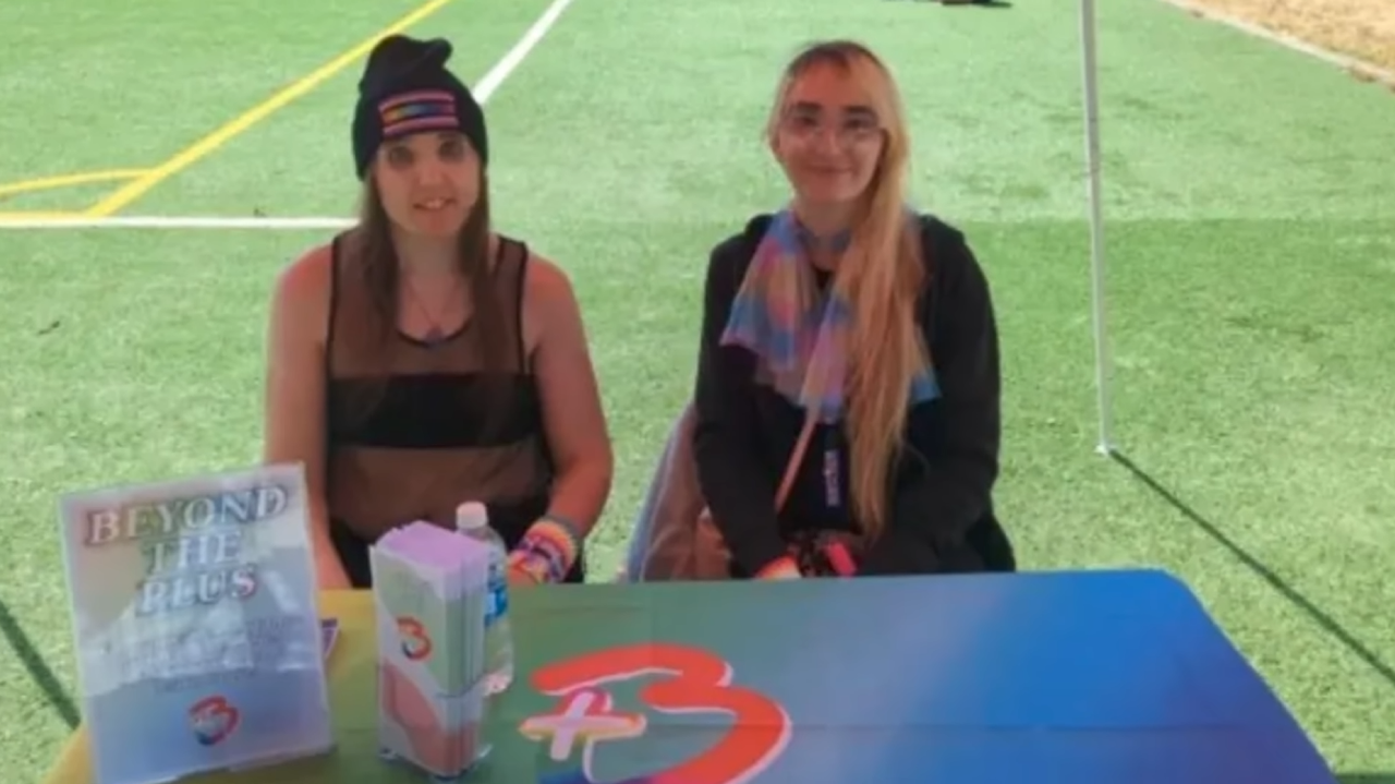 photograph of Ally Kotetsu and her partner Violet sitting at the beyond the plus booth